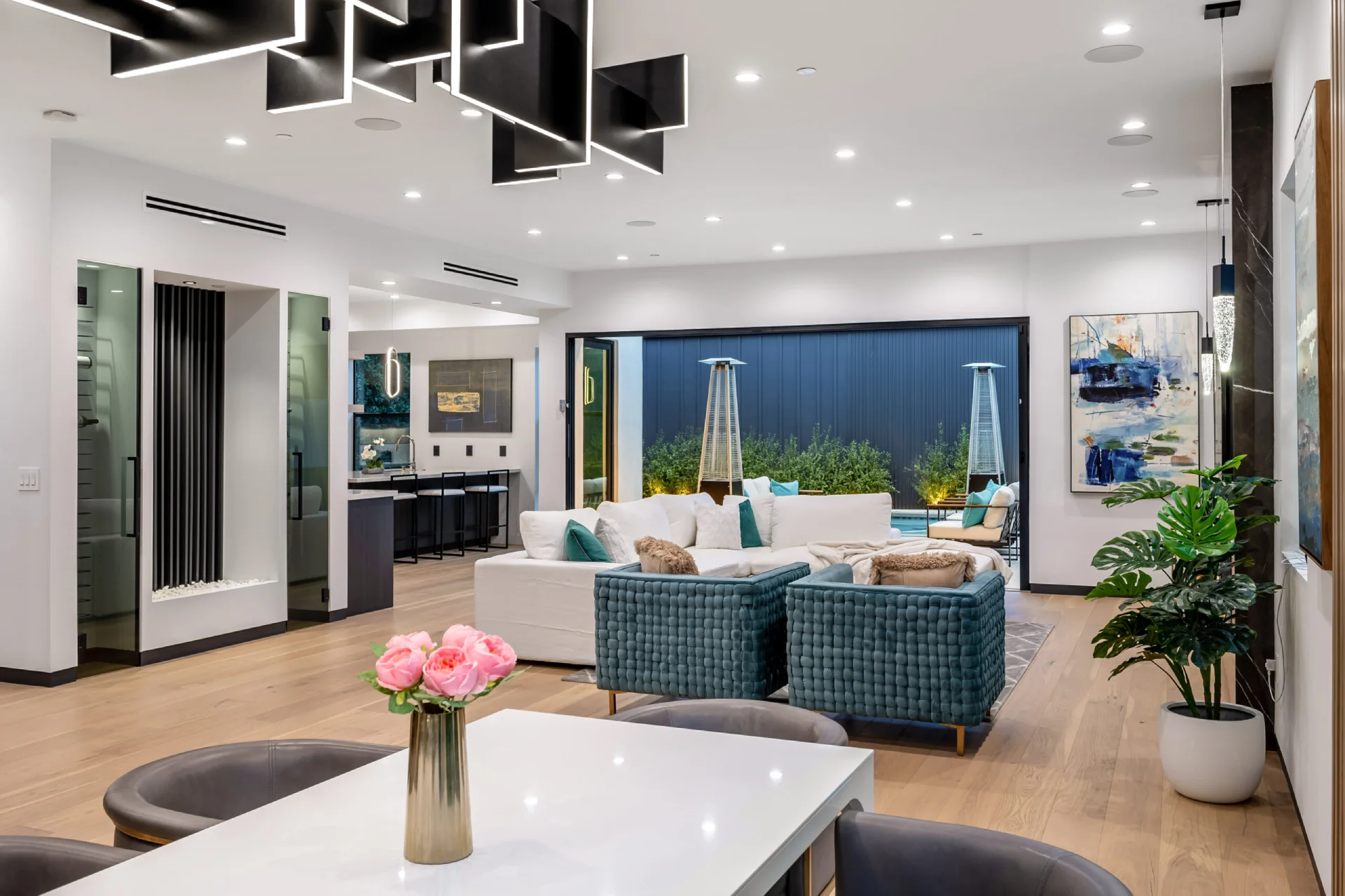 Stylish open-concept living space with unique ceiling lighting and contemporary decor.